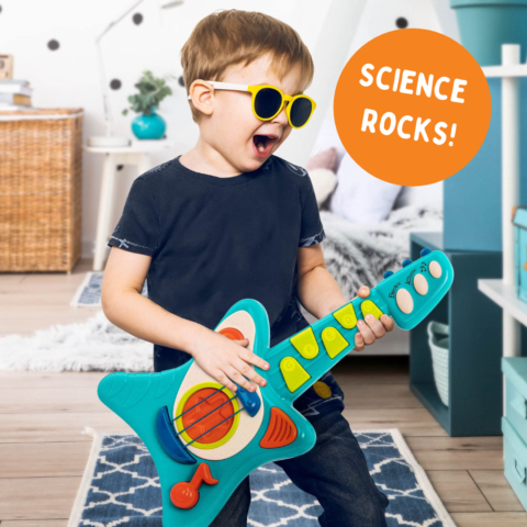 young boy playing a toy guitar with the text science rocks!